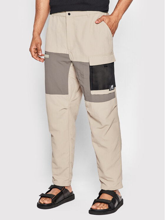 New Balance Medžiaginės kelnės · Smėlio · Relaxed Fit